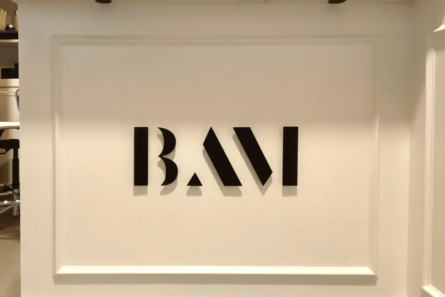 An interior office sign with black anodized aluminum sign letters.