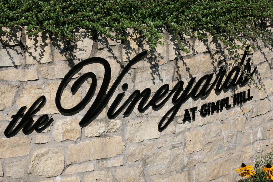An exterior monument sign for a vineyard with black anodized aluminum sign letters.