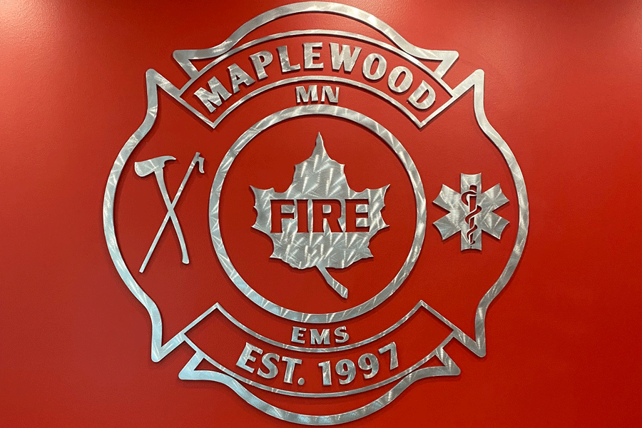 A lobby sign with radial arch brushed aluminum sign letters and shapes.