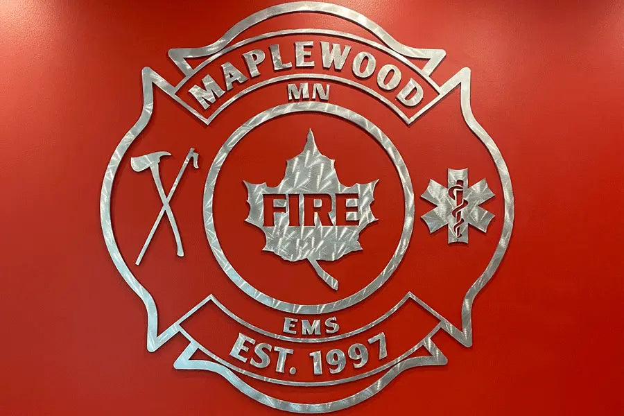 A lobby sign with radial arch brushed aluminum sign letters and shapes.