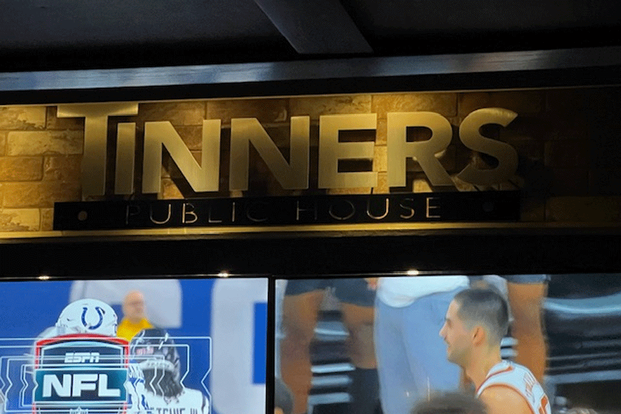 A gold anodized aluminum restaurant sign for Tinners Public House.