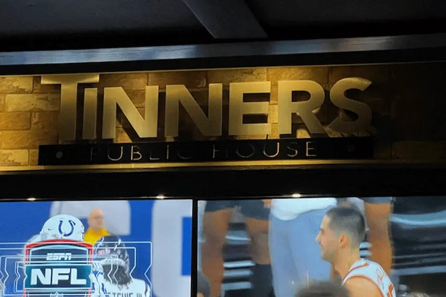 A gold anodized aluminum restaurant sign for Tinners Public House.