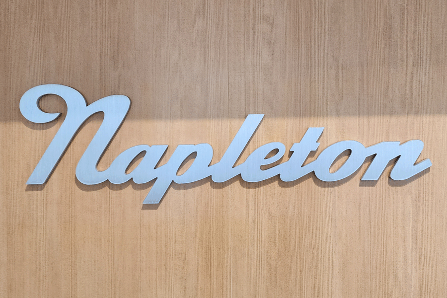 A flat cut aluminum lobby sign with a brushed finish.