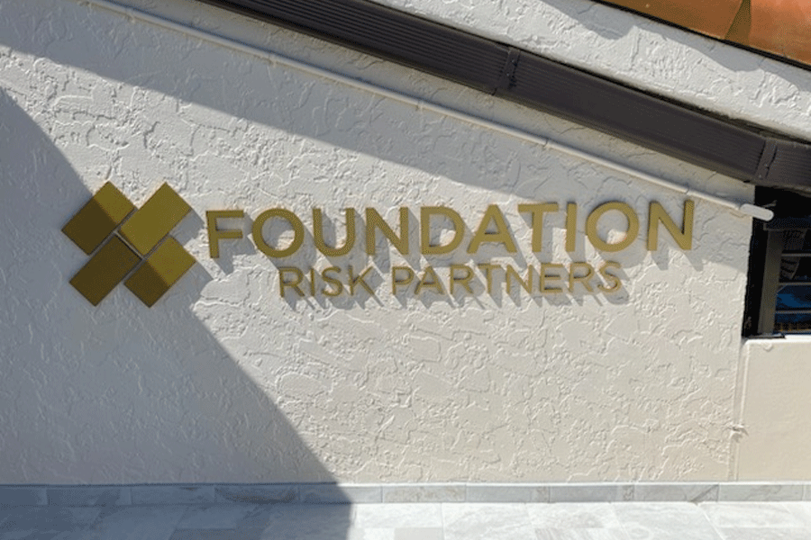 An exterior wall sign for Foundation Risk Partners with anodized bronze aluminum sign letters.