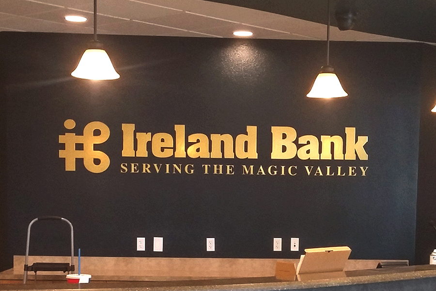 Bank lobby sign with brass sign letters.