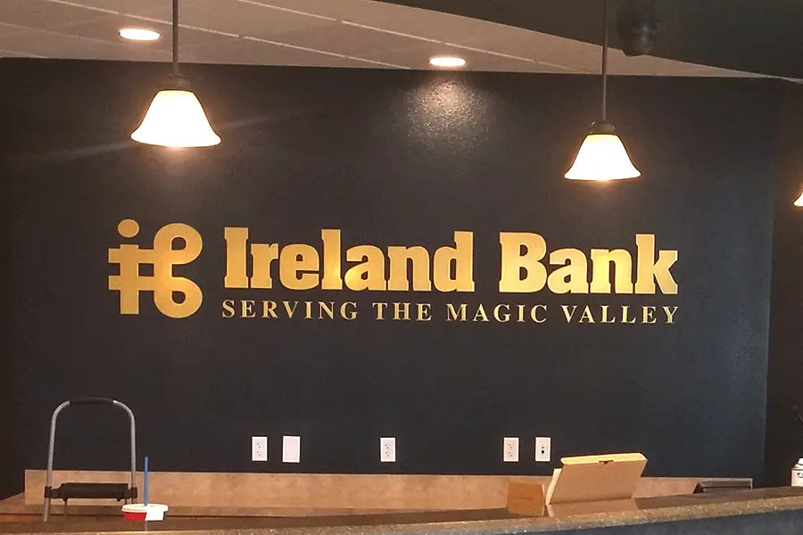 Bank lobby sign with brass sign letters.