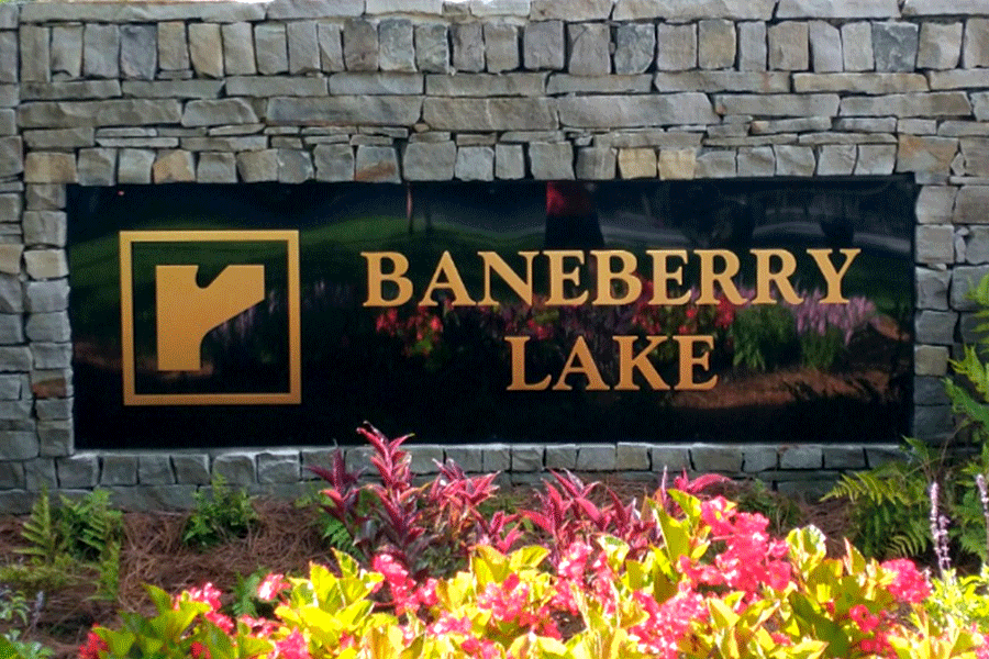 Monument sign with brass sign letters and shapes.