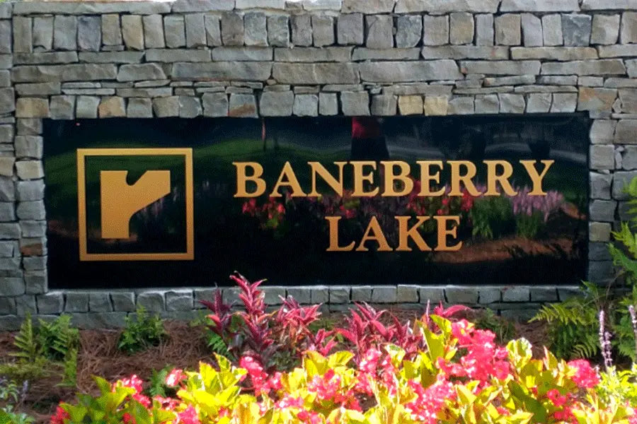 Monument sign with brass sign letters and shapes.