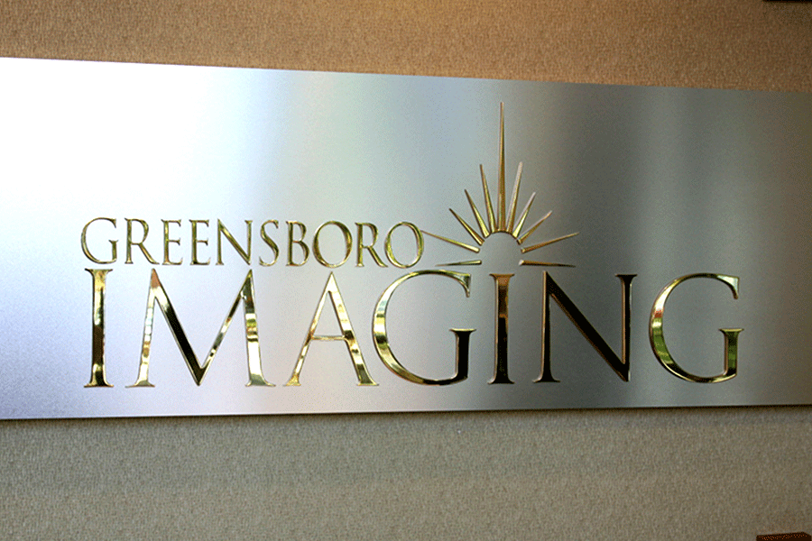 Lobby sign with polished brass sign letters and shapes.