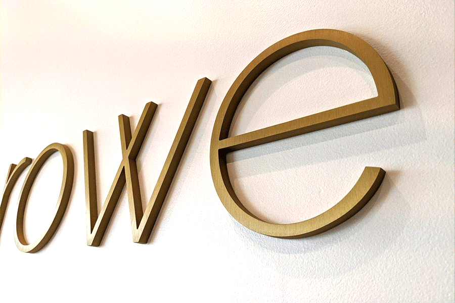 Lobby sign with brushed brass sign letters.