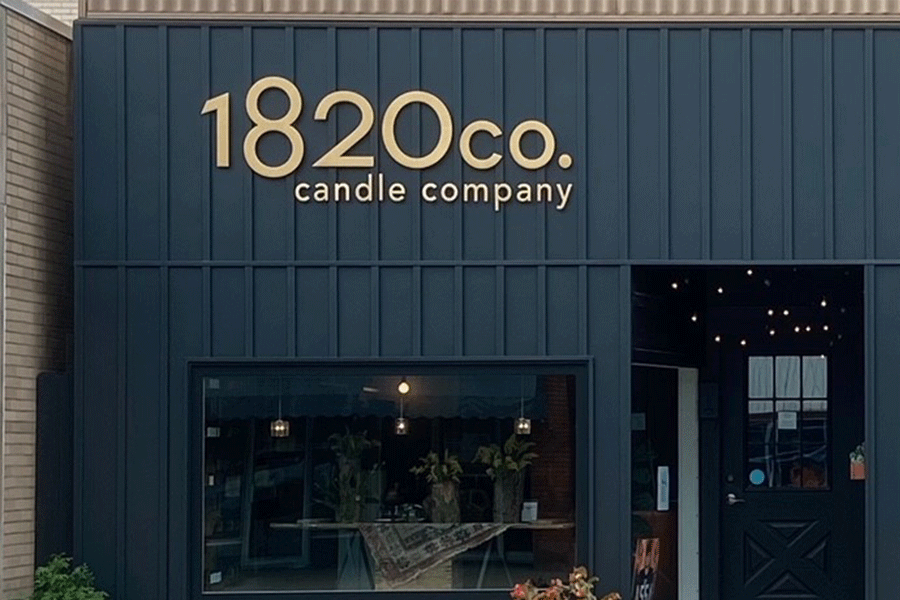 Storefront sign with brushed brass sign letters.