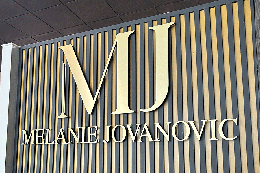 Beauty salon sign with polished brass sign letters.