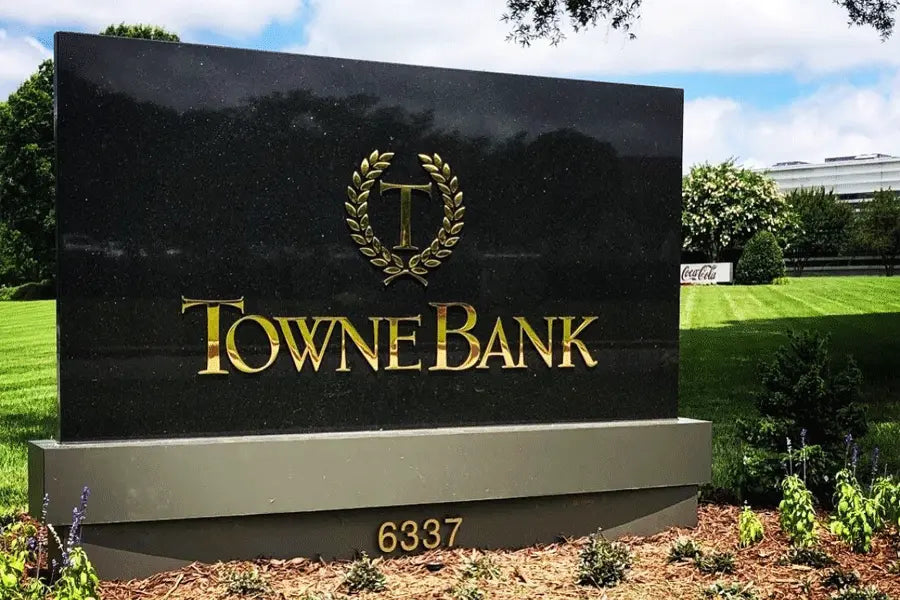 Monument sign with polished brass sign letters and address numbers