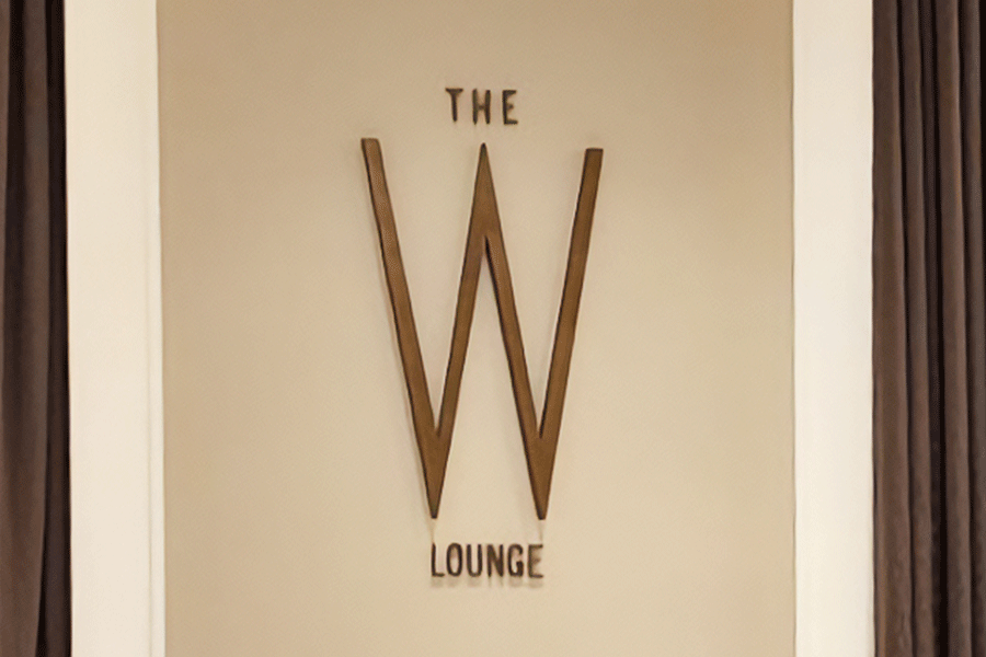 Restaurant sign with aged brass sign letters and elements.