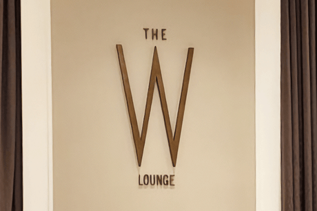 Restaurant sign with aged brass sign letters and elements.