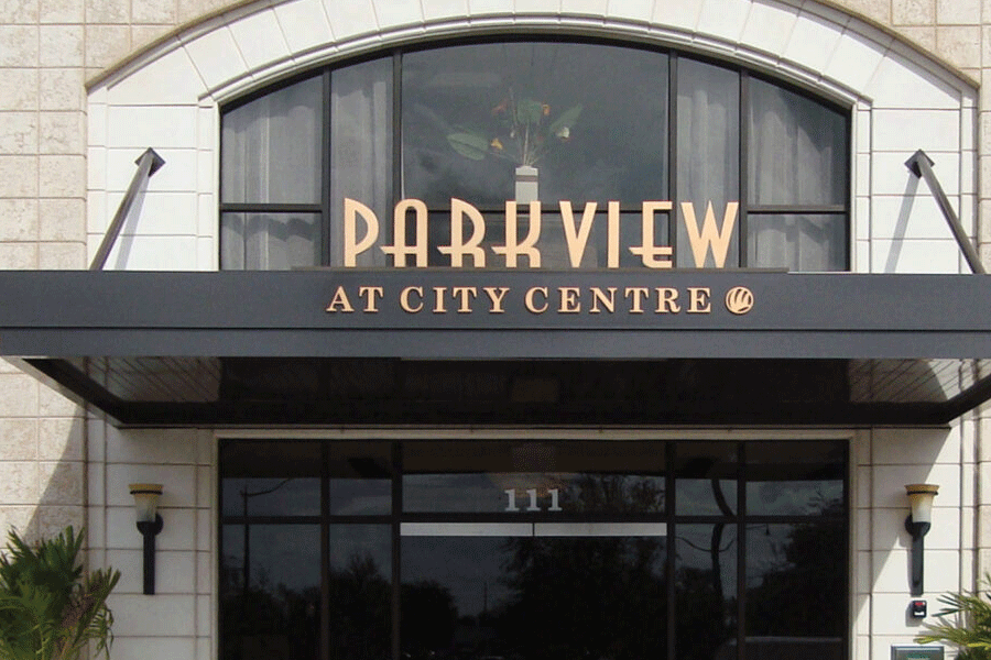 Awning sign with polished bronze sign letters.