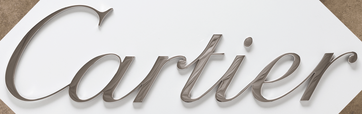 A storefront sign with polished bronze sign letters.