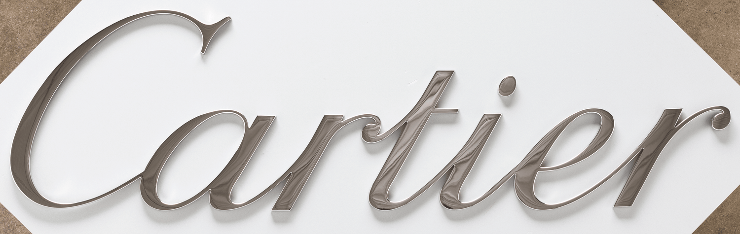 A storefront sign with polished bronze sign letters.