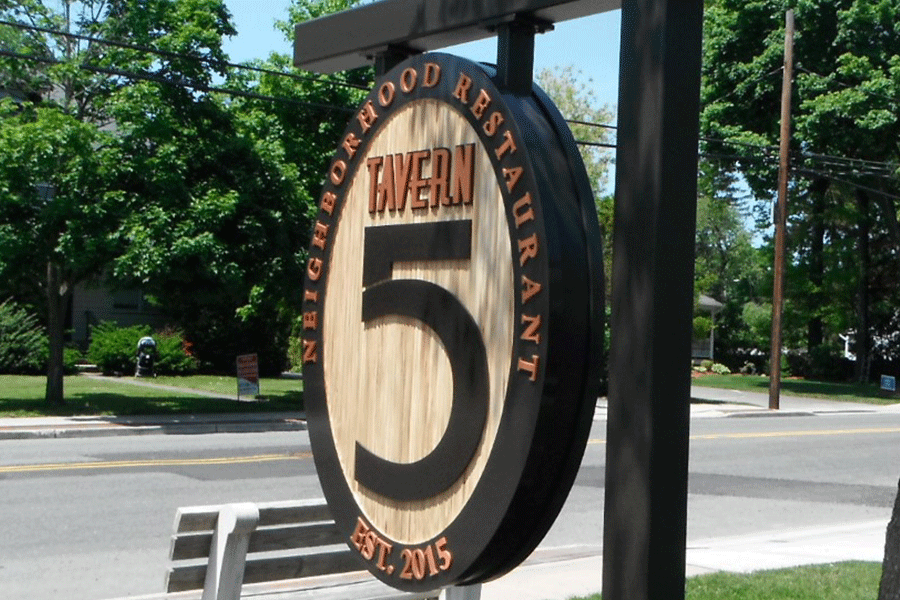 Hanging tavern side with copper sign letters.