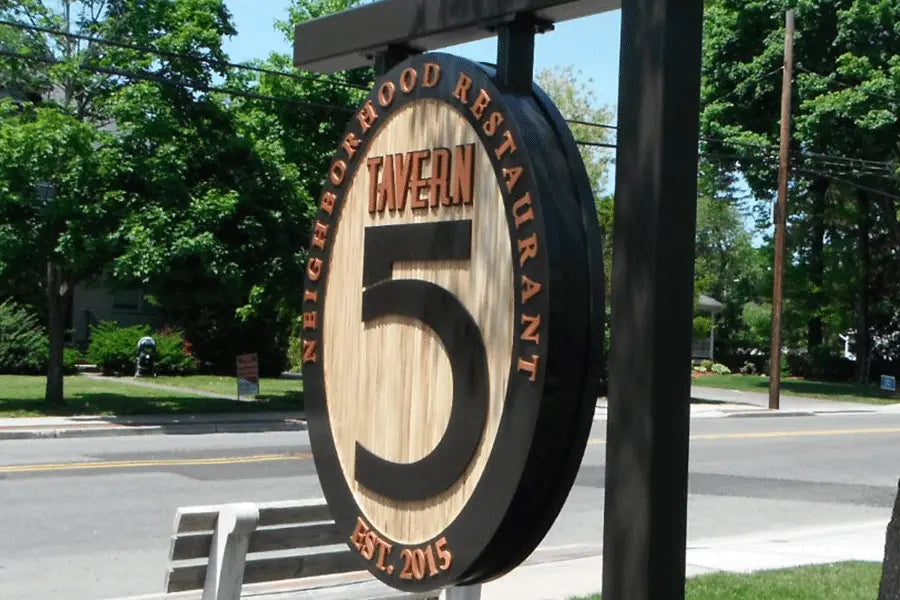 Hanging tavern side with copper sign letters.