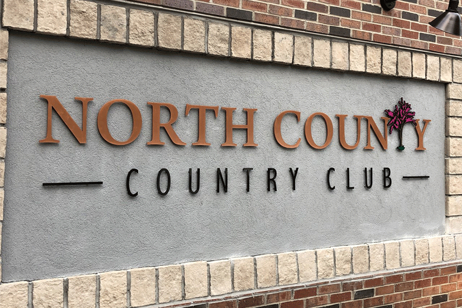 Country club sign with copper sign letters and painted metal elements.