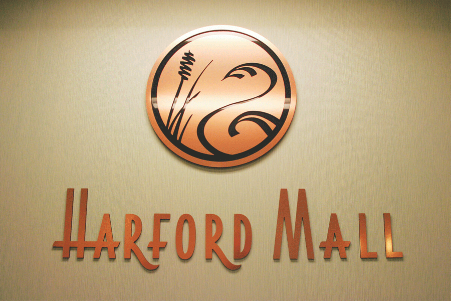 Mall sign with copper sign letters and a copper logo.