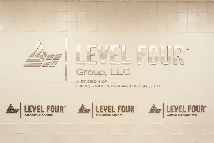 Agency sign with polished stainless steel sign letters and shapes.