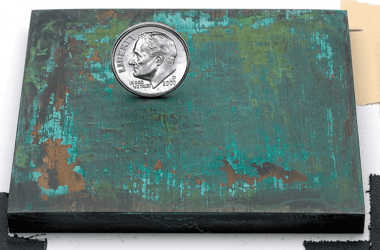 Sample of a verde bronze or brass patina finish for sign letters.