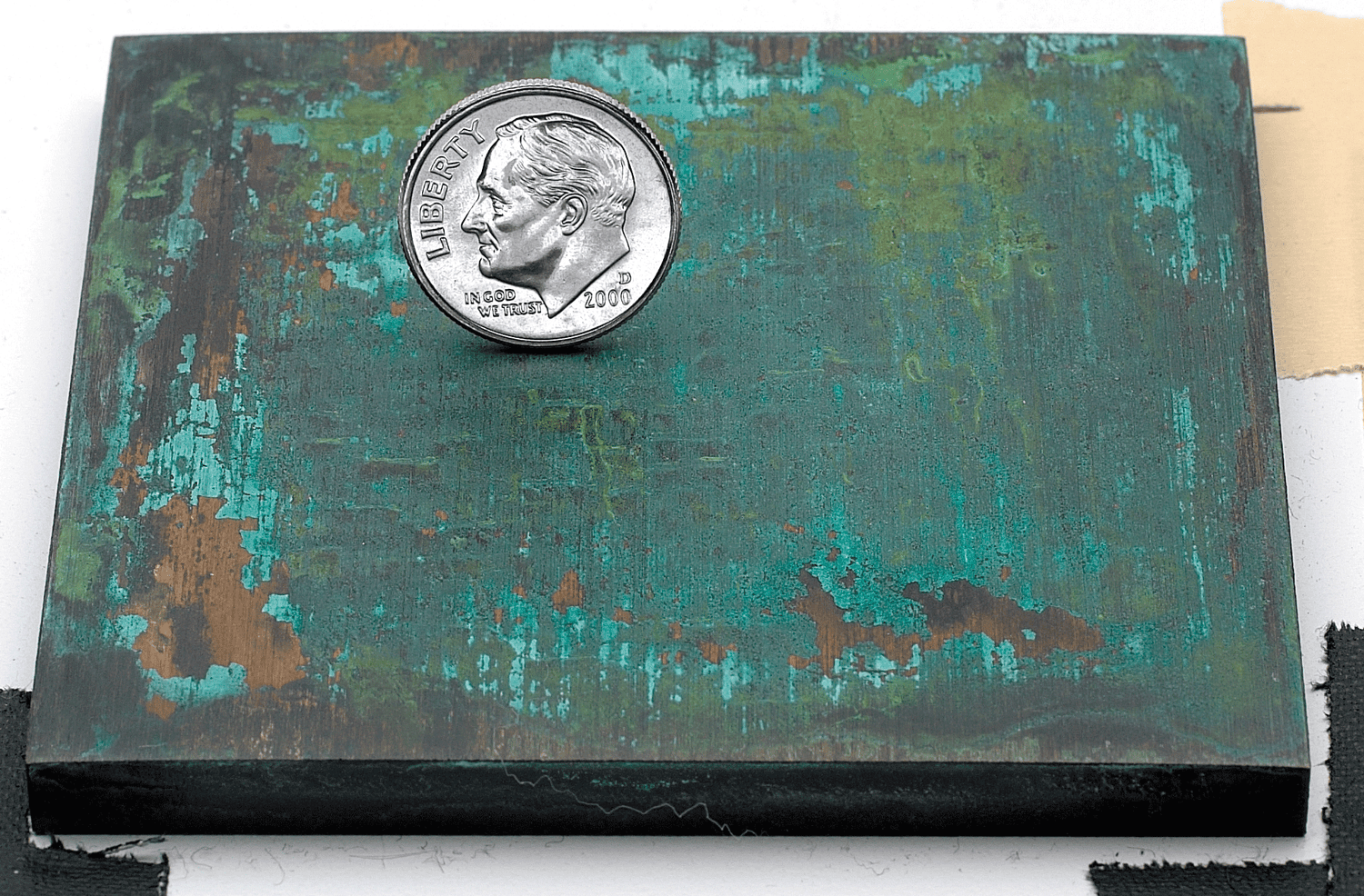 Sample of a verde bronze or brass patina finish for sign letters.