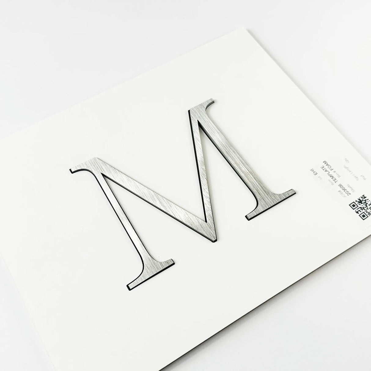 Brushed stainless steel division 10 architectural sign letter with double-sided tape on mounting template