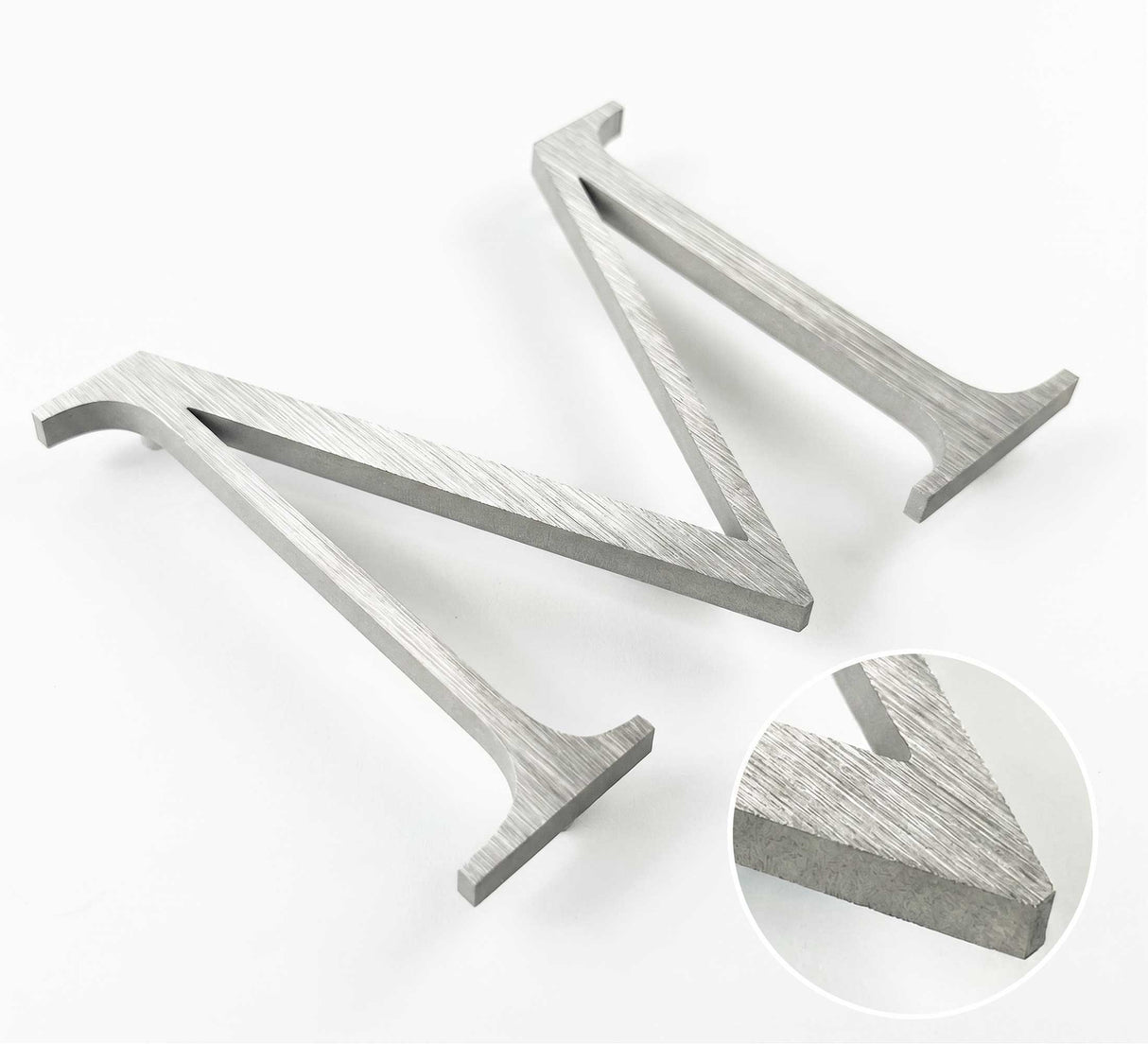 Vertically brushed 316 stainless steel division 10 architectural sign letter with finish closeup
