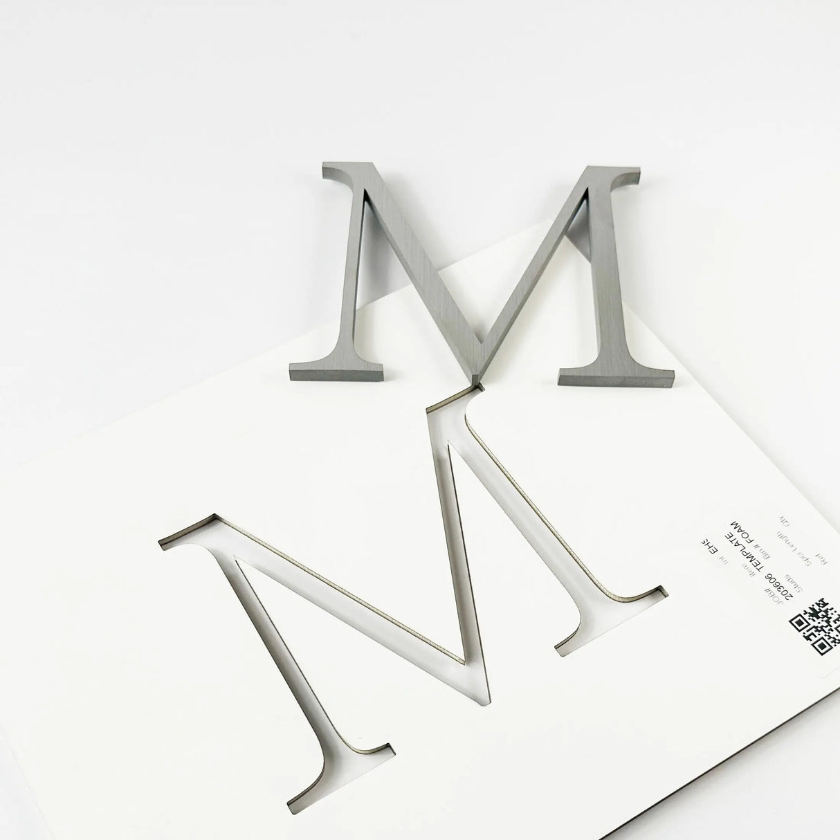 Brushed stainless steel division 10 architectural sign letter with double-sided tape on mounting template