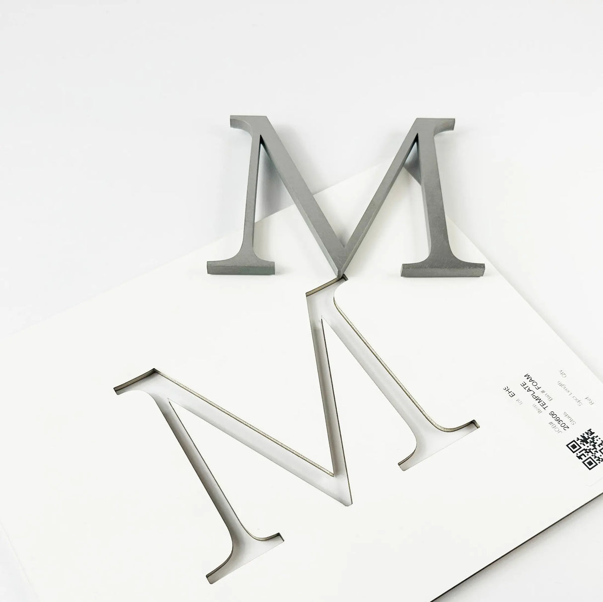 Orbital brushed stainless steel division 10 architectural sign letter with double-sided tape on mounting template
