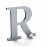 Radial brushed aluminum sign letter R.