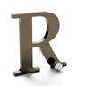 Aged bronze sign letter R.