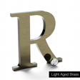 Lightly aged brass sign letter R.