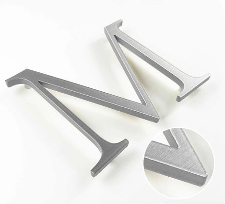 Horizontally brushed solid aluminum division 10 architectural sign letter with finish closeup