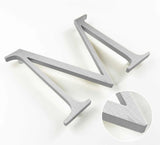 Vertically brushed solid aluminum division 10 architectural sign letter with finish closeup