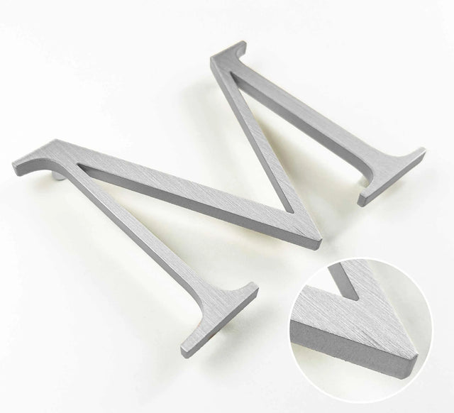 Vertically brushed solid aluminum division 10 architectural sign letter with finish closeup