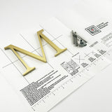 Brushed solid brass division 10 architectural sign letter on mounting template with hardware