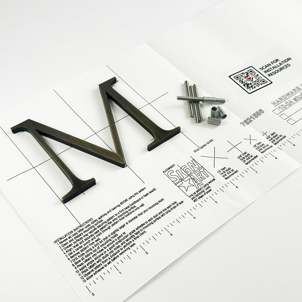 Heavily aged solid brass division 10 architectural sign letter on mounting template with hardware