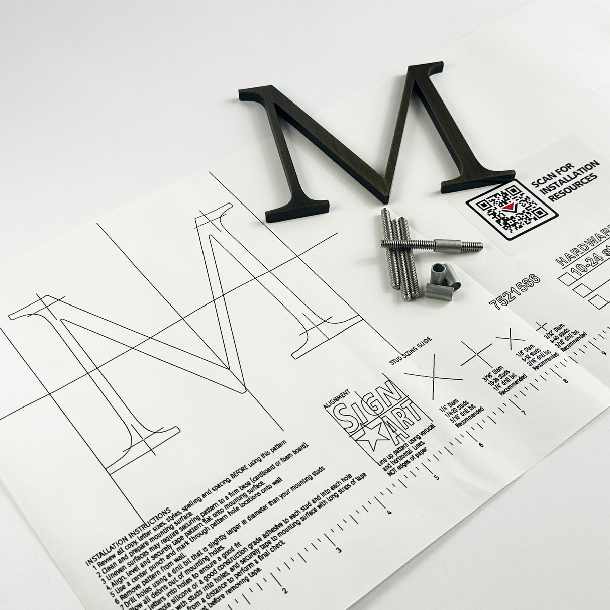 Heavily aged solid brass division 10 architectural sign letter on mounting template with hardware