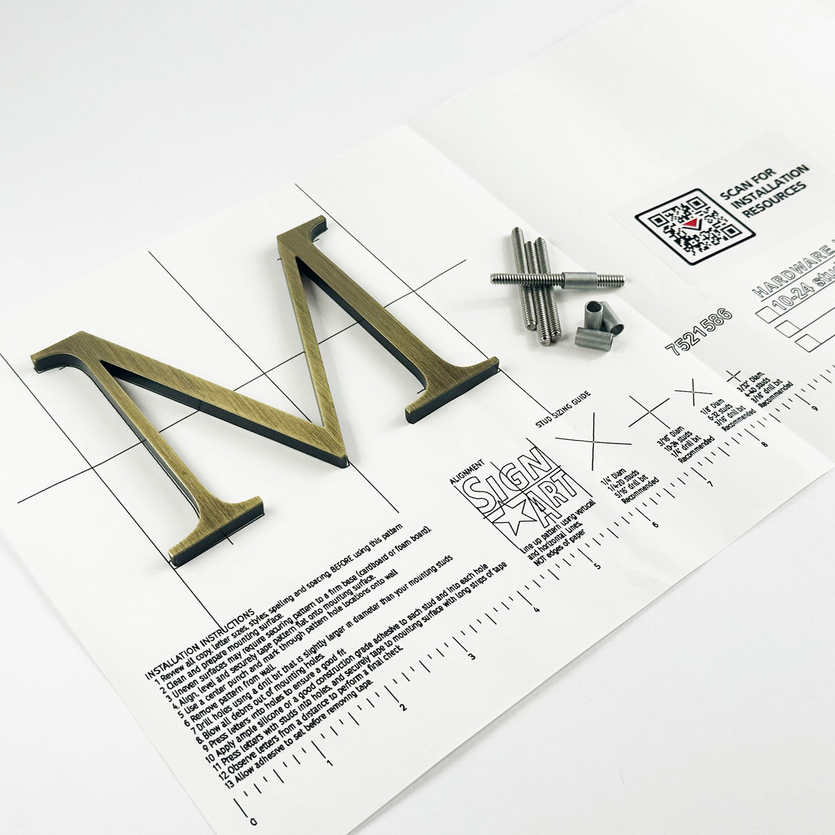 Lightly aged solid brass division 10 architectural sign letter on mounting template with hardware