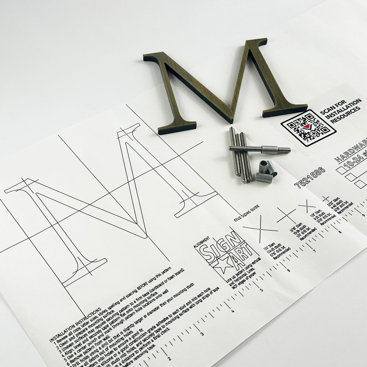 Lightly aged solid brass division 10 architectural sign letter on mounting template with hardware