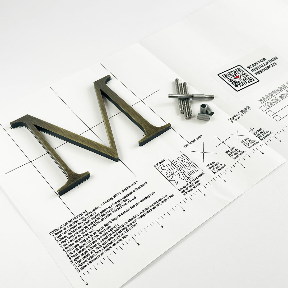 Aged solid brass division 10 architectural sign letter on mounting template with hardware