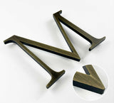 Heavily aged solid BAA & BABA certified brass division 10 architectural sign letter with finish closeup
