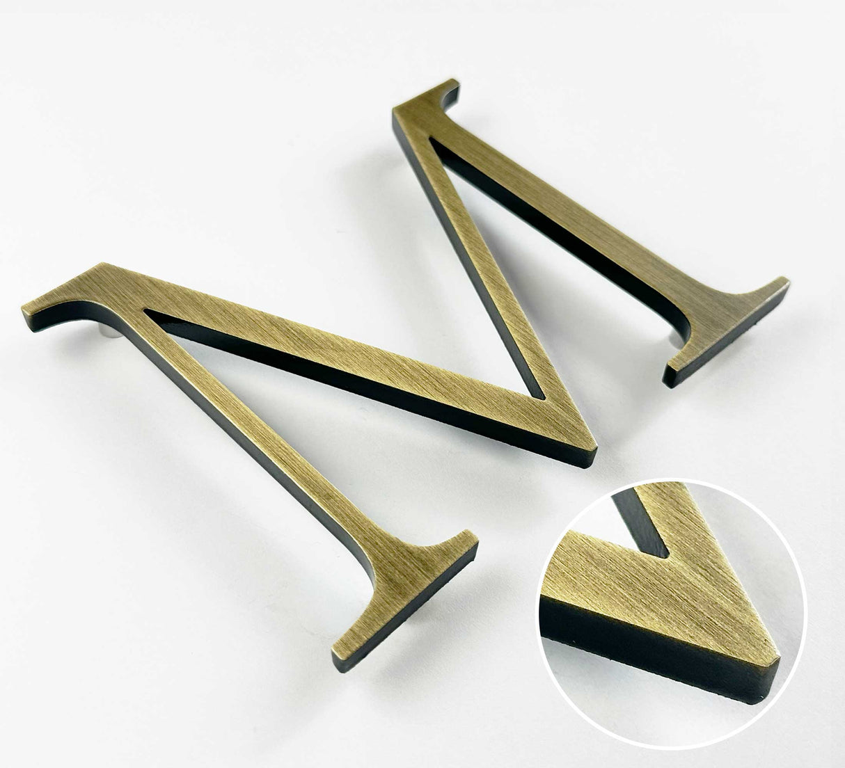 Lightly aged solid BAA & BABA certified brass division 10 architectural sign letter with finish closeup