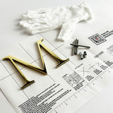 Polished solid brass sign letters with hardware and mounting template.