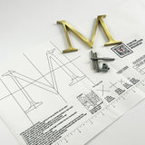 Random arc brushed solid brass division 10 architectural sign letter on mounting template with hardware