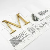 Vertically brushed solid bronze division 10 architectural sign letter on mounting template with hardware
